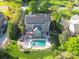 Aerial view of a brick home featuring a pool, deck, and solar panels at 9433 Stonebridge Way, Mint Hill, NC 28227