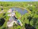 Aerial view of a beautiful home with a private pool and access to a serene lake at 9433 Stonebridge Way, Mint Hill, NC 28227