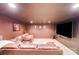 Cozy media room with a large TV, comfortable couch, and recessed lighting at 9433 Stonebridge Way, Mint Hill, NC 28227