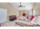Inviting bedroom with a cozy quilt, ceiling fan, and natural light from the three windows at 9433 Stonebridge Way, Mint Hill, NC 28227
