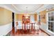 Bright dining room features hardwood floors, an elegant chandelier, a built-in china cabinet and wainscoting at 9433 Stonebridge Way, Mint Hill, NC 28227