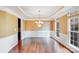 Bright dining room featuring a stylish chandelier, tray ceiling, and beautiful hardwood floors at 9433 Stonebridge Way, Mint Hill, NC 28227
