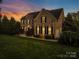 Beautiful brick home with lush landscaping and a well-maintained lawn at 9433 Stonebridge Way, Mint Hill, NC 28227