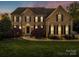 Stately brick home with manicured lawn, elegant entryway, and classic architectural details at 9433 Stonebridge Way, Mint Hill, NC 28227