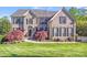 Beautiful brick home featuring manicured lawn, lush landscaping and black shutters at 9433 Stonebridge Way, Mint Hill, NC 28227