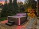Relax and unwind in this modern hot tub with illuminated accents and a tranquil waterfall feature at 9433 Stonebridge Way, Mint Hill, NC 28227