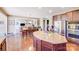Gourmet kitchen with granite countertops, stainless steel appliances, an island with seating and hardwood floors at 9433 Stonebridge Way, Mint Hill, NC 28227