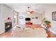 Inviting living room features a cozy fireplace, hardwood floors, and large windows for natural light at 9433 Stonebridge Way, Mint Hill, NC 28227