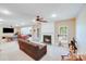 Comfortable living room featuring a fireplace, ceiling fan, and ample space for furnishings at 9433 Stonebridge Way, Mint Hill, NC 28227