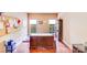 Office features hardwood floors, large windows, and plenty of natural light. A large desk sits in the center of the room at 9433 Stonebridge Way, Mint Hill, NC 28227