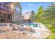 A luxurious in-ground pool with lounge chairs and stone accents offers a relaxing backyard retreat at 9433 Stonebridge Way, Mint Hill, NC 28227