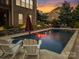 Relax by the pool in this backyard oasis with stone accents and an inviting atmosphere at 9433 Stonebridge Way, Mint Hill, NC 28227