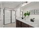 Bright bathroom featuring a double sink vanity with modern fixtures and a glass-enclosed shower at 9527 Teamwork Nw St, Concord, NC 28027