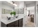 Beautiful bathroom with a double sink vanity with decorative plants and framed art at 9527 Teamwork Nw St, Concord, NC 28027