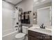 Functional bathroom featuring a tub with a shower and a single-sink vanity with a framed mirror at 9527 Teamwork Nw St, Concord, NC 28027