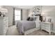 Comfortable bedroom with a queen-sized bed, side tables with lamps, and a window at 9527 Teamwork Nw St, Concord, NC 28027