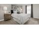 Cozy bedroom with a queen-sized bed, side tables, neutral walls, and patterned curtains at 9527 Teamwork Nw St, Concord, NC 28027