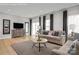 Inviting living room features neutral tones, modern decor, and an open layout with wood-style flooring at 9527 Teamwork Nw St, Concord, NC 28027