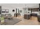 Open-concept living area with modern furnishings, light wood floors, and a connected kitchen at 9527 Teamwork Nw St, Concord, NC 28027