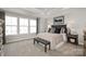 Serene bedroom featuring a large window, modern decor, and a tray ceiling for added elegance at 9527 Teamwork Nw St, Concord, NC 28027