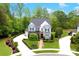 Stunning aerial view of a beautiful home with manicured landscaping, a circular driveway and mature trees at 9596 Pacing Nw Ln, Concord, NC 28027