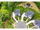 Expansive aerial view showcasing the beautifully landscaped properties, circular driveways, and surrounding greenery at 9596 Pacing Nw Ln, Concord, NC 28027