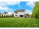 Beautiful backyard featuring a lush lawn and the home's light gray exterior, offering great outdoor space at 9596 Pacing Nw Ln, Concord, NC 28027