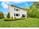 The backyard features a well-maintained lawn, manicured landscaping, and a covered outdoor patio at 9596 Pacing Nw Ln, Concord, NC 28027
