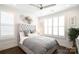 Stylish bedroom featuring a tufted headboard, plush bedding, and ample natural light through shuttered windows at 9596 Pacing Nw Ln, Concord, NC 28027