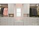 Spacious walk-in closet with custom gray cabinetry and drawers for ample storage at 9596 Pacing Nw Ln, Concord, NC 28027