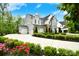 Beautiful two-story home with a lush front yard and long driveway leading to a three-car garage at 9596 Pacing Nw Ln, Concord, NC 28027