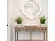 Foyer console table with a decorative mirror and floral accents at 9596 Pacing Nw Ln, Concord, NC 28027