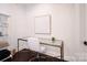 Bright home office featuring a glass topped desk, modern art and white shelving at 9596 Pacing Nw Ln, Concord, NC 28027