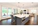 Open-concept kitchen featuring a large island with seating, modern appliances, and seamless access to the living spaces at 9596 Pacing Nw Ln, Concord, NC 28027