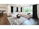 Elegant living room featuring a large sectional sofa, area rug, and large windows with dark curtains at 9596 Pacing Nw Ln, Concord, NC 28027