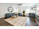Spacious living room with ceiling fan, modern furnishings, and light wood flooring at 9596 Pacing Nw Ln, Concord, NC 28027