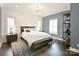 Bedroom with painted brick wall, hardwood floors, and modern furnishings at 9596 Pacing Nw Ln, Concord, NC 28027