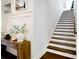 Entry way featuring staircase with dark wood treads, white risers, and wood flooring at 9596 Pacing Nw Ln, Concord, NC 28027