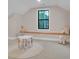 This attic area has natural light, a small table and chairs, and a seating area at 10125 Bethel Church Rd, Midland, NC 28107