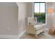 This attic room features a reading chair by a window with natural light at 10125 Bethel Church Rd, Midland, NC 28107