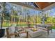 Cozy back porch featuring a modern fire pit and comfortable seating overlooking the backyard at 10125 Bethel Church Rd, Midland, NC 28107