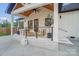 Stylish back porch with a cozy seating area, fire pit, and modern railings at 10125 Bethel Church Rd, Midland, NC 28107
