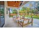Relaxing back porch with a fire pit and views of the expansive backyard with a playground at 10125 Bethel Church Rd, Midland, NC 28107