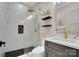Beautifully designed bathroom showcasing a tiled walk-in shower with black trim and floating wood shelves at 10125 Bethel Church Rd, Midland, NC 28107