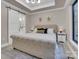 Stylish bedroom with large tufted bed, sliding barn door to the bathroom, and view of the outdoor scenery at 10125 Bethel Church Rd, Midland, NC 28107