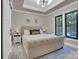 Comfortable bedroom with tufted bed, overhead lighting, and ample natural light from the large black trimmed windows at 10125 Bethel Church Rd, Midland, NC 28107