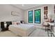 Cozy bedroom with a modern minimalist style with decor, a bedside table, and black trimmed windows at 10125 Bethel Church Rd, Midland, NC 28107