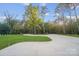 Expansive driveway leading to a meticulously landscaped home surrounded by mature trees and lush greenery at 10125 Bethel Church Rd, Midland, NC 28107