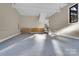 This garage has a large open space with gray floors and storage cabinets along the back wall at 10125 Bethel Church Rd, Midland, NC 28107