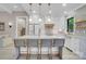 Beautiful kitchen island with barstool seating, modern pendant lights, and white cabinets at 10125 Bethel Church Rd, Midland, NC 28107